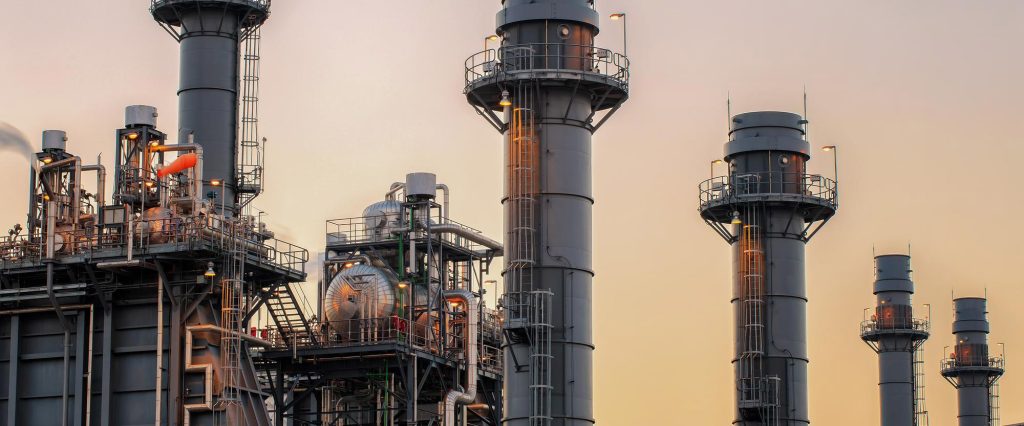 low-angle-view-industrial-building-against-sky-sunset