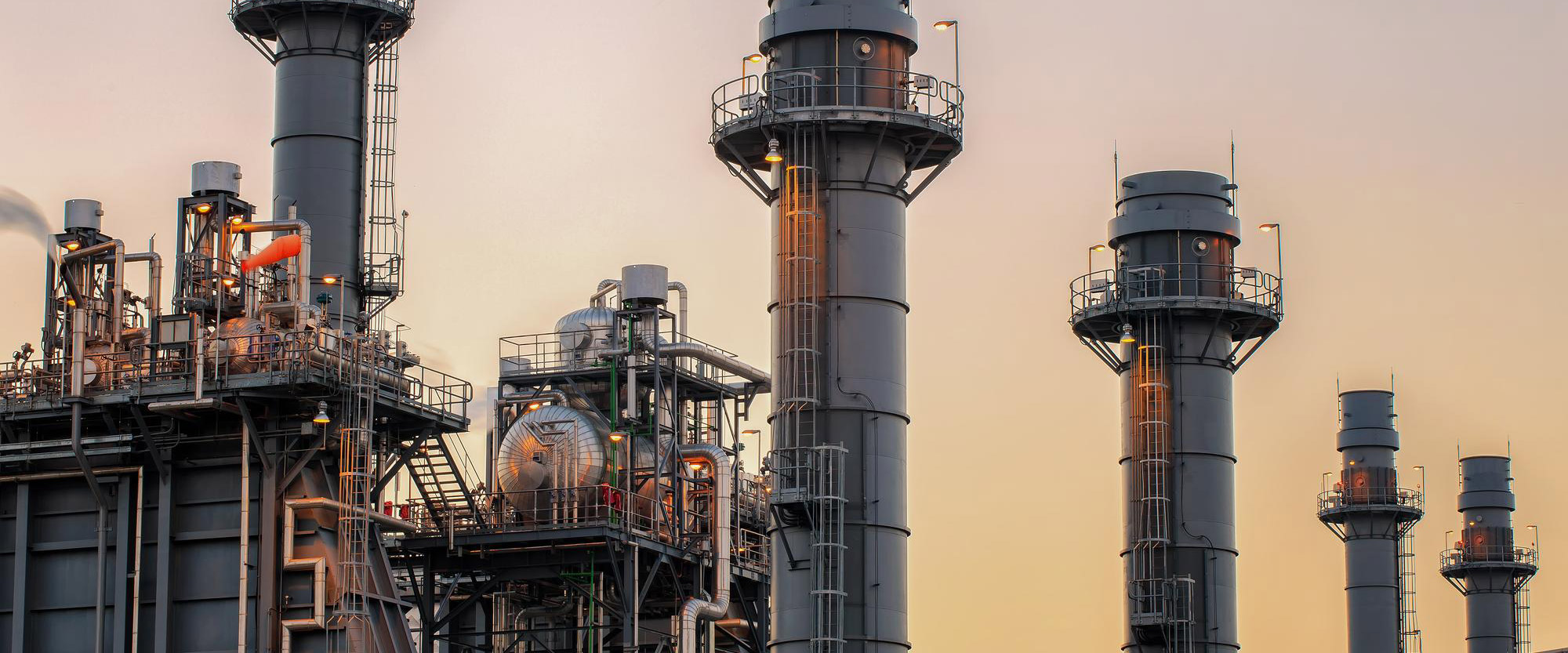 low-angle-view-industrial-building-against-sky-sunset